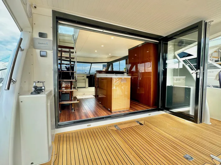 Waves III Yacht Photos Pics Luxurious 2017 Maritimo M51 yacht interior with open sliding doors and wooden flooring.