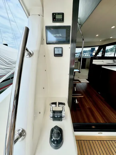 Waves III Yacht Photos Pics 2017 Maritimo M51 yacht helm with Garmin navigation, joystick control, and luxurious interior.
