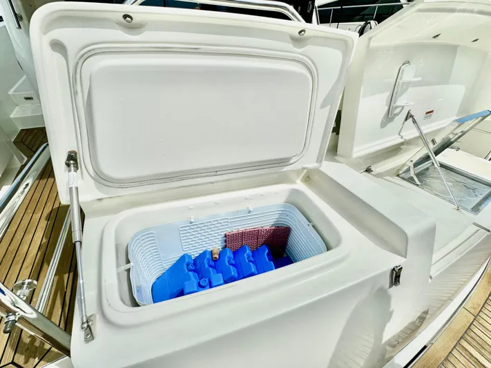 Waves III Yacht Photos Pics Open cooler on 2017 Maritimo M51 yacht deck, featuring ice packs and storage space.