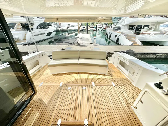 Waves III Yacht Photos Pics 2017 Maritimo M51 yacht deck with seating, docked at marina.
