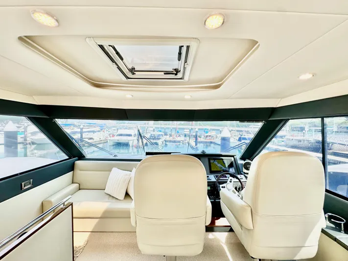 Waves III Yacht Photos Pics Interior of 2017 Maritimo M51 yacht with plush seating and panoramic windows.