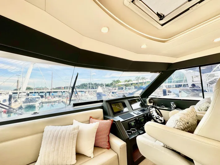 Waves III Yacht Photos Pics Interior view of 2017 Maritimo M51 yacht with plush seating and marina backdrop.