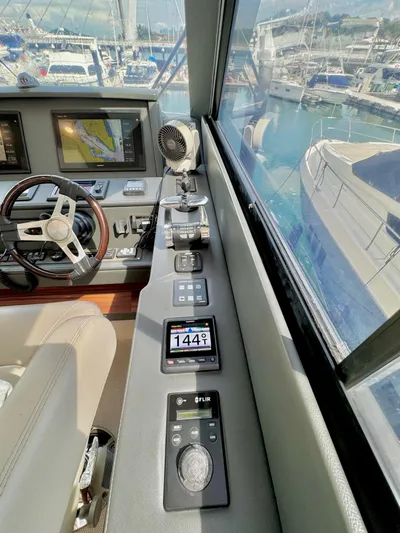 Waves III Yacht Photos Pics 2017 Maritimo M51 yacht helm with navigation controls and marina view.