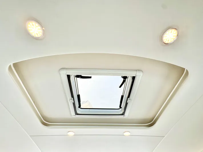 Waves III Yacht Photos Pics Ceiling hatch with lights on 2017 Maritimo M51 yacht interior.