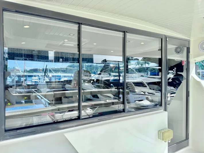 Waves III Yacht Photos Pics 2017 Maritimo M51 yacht interior with large windows and marina view.
