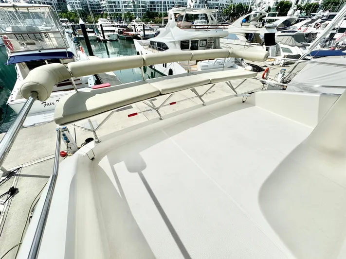 Waves III Yacht Photos Pics 2017 Maritimo M51 yacht deck with seating, docked at marina with other boats.