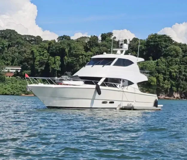 Waves III Yacht Photos Pics 2017 Maritimo M51 yacht on calm water with lush green shoreline.