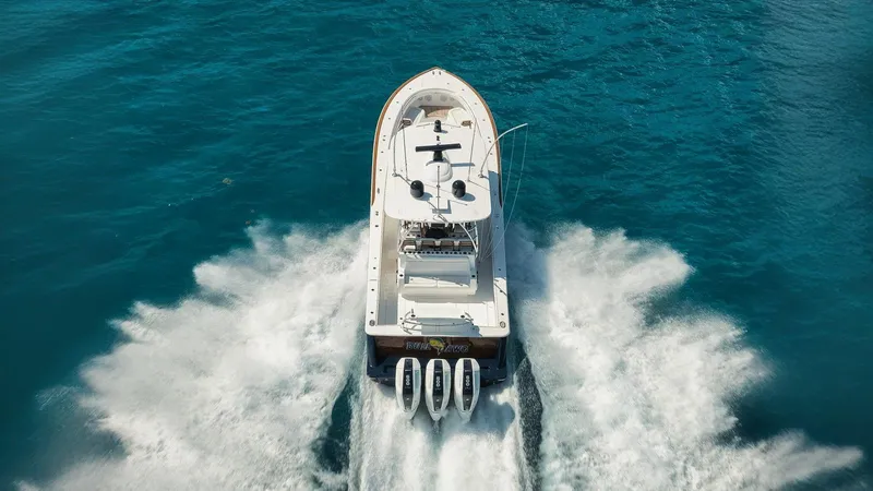 Bulldawg Yacht Photos Pics 2023 Valhalla Boatworks V-46 cruising on clear blue water, aerial view.