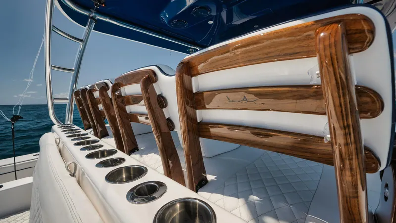 Bulldawg Yacht Photos Pics Luxurious 2023 Valhalla V-46 boat interior with elegant wooden seating and cup holders.