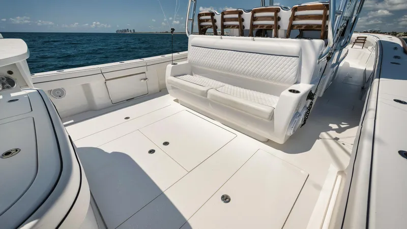 Bulldawg Yacht Photos Pics 2023 Valhalla Boatworks V-46 deck with white seating, ocean view.