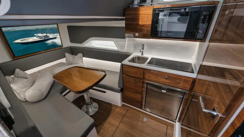 Bulldawg Yacht Photos Pics Luxurious interior of 2023 Valhalla Boatworks V-46 with modern kitchen and seating area.