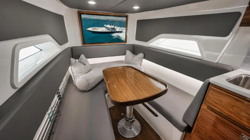 Bulldawg Yacht Photos Pics 2023 Valhalla V-46 cabin interior with sleek seating, wooden table, and modern design.