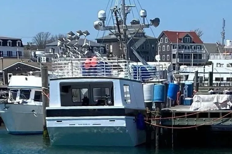 Nova Blue Yacht Photos Pics Commercial Long Liner boat docked at a marina, surrounded by buildings, 1992 model.