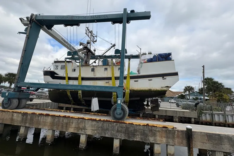 Nova Blue Yacht Photos Pics A 1992 Commercial Long Liner boat being lifted at a marina dock.