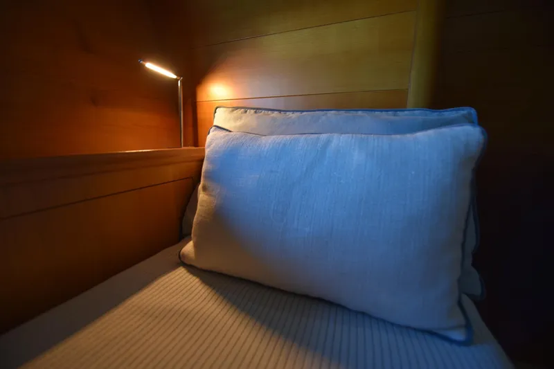 Green Eyes Yacht Photos Pics Cozy cabin interior of 2001 Wally Full Displacement Sailing Yacht with soft lighting and pillow.
