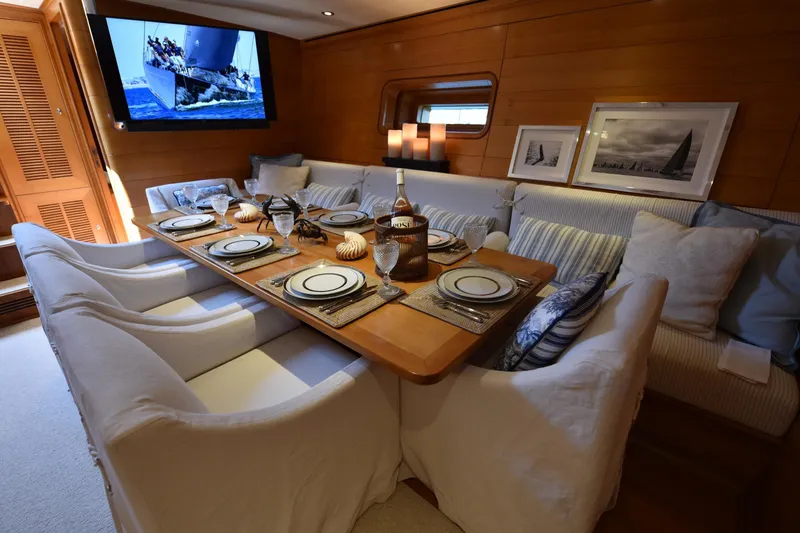 Green Eyes Yacht Photos Pics Luxurious dining area on a 2001 Wally Full Displacement Sailing Yacht, elegantly set table.