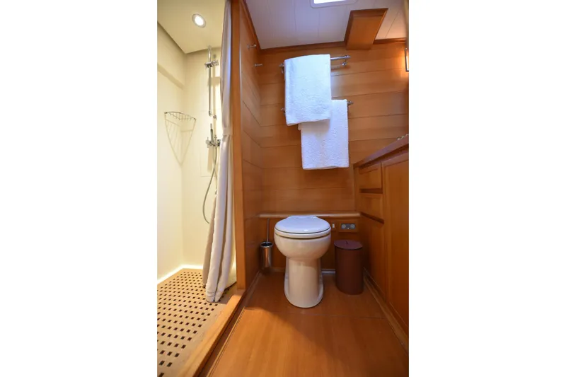 Green Eyes Yacht Photos Pics Luxurious yacht bathroom with wooden accents, shower, and towels; Wally Full Displacement, 2001.