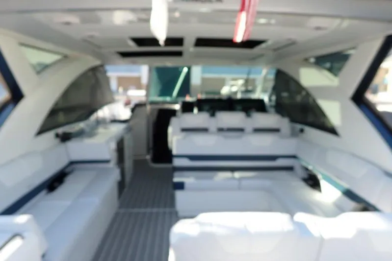  Yacht Photos Pics Blurry interior of 2026 Formula 430 Super Sport Crossover boat with white seating.