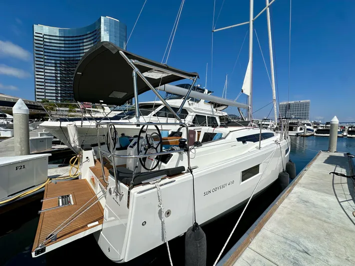 Endless Summer Yacht Photos Pics 2024 Jeanneau Sun Odyssey 410 yacht docked at marina under clear blue sky.