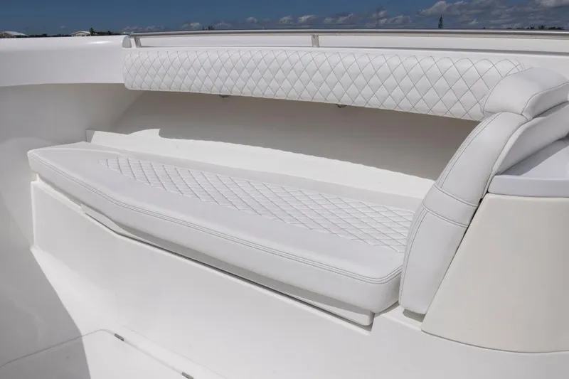  Yacht Photos Pics Luxurious white seating on 2023 HCB 39 Speciale boat, featuring diamond-pattern upholstery.