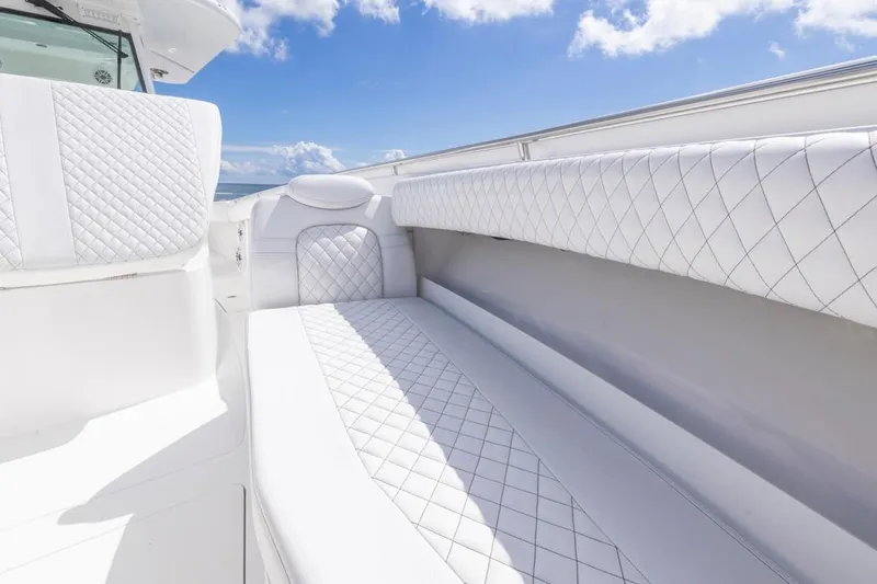  Yacht Photos Pics Luxurious white seating on 2023 HCB 39 Speciale boat under blue sky.