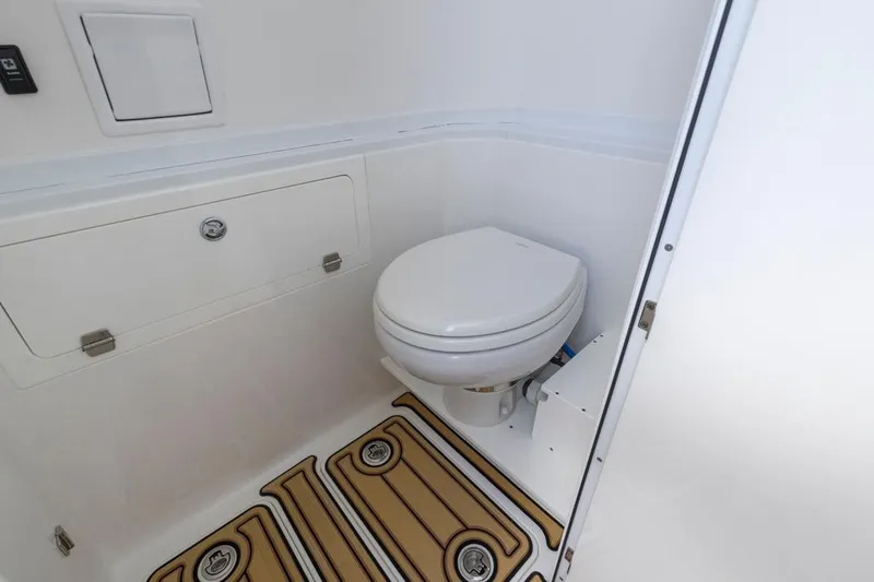  Yacht Photos Pics 2023 HCB 39 Speciale boat interior with compact marine toilet and storage compartment.