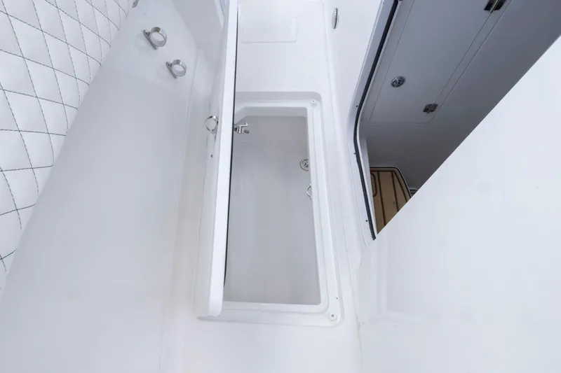  Yacht Photos Pics Interior view of 2023 HCB 39 Speciale boat, featuring sleek white design and storage compartment.