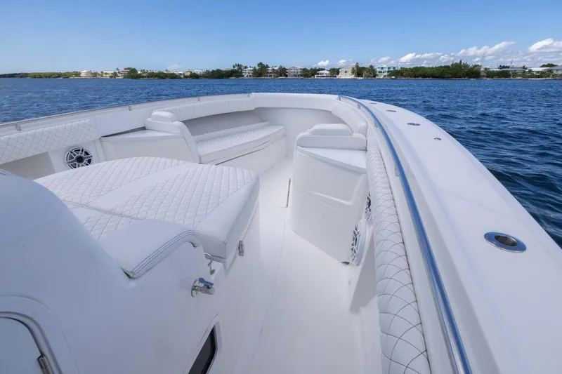  Yacht Photos Pics 2023 HCB 39 Speciale luxury boat interior with white seating on calm water.