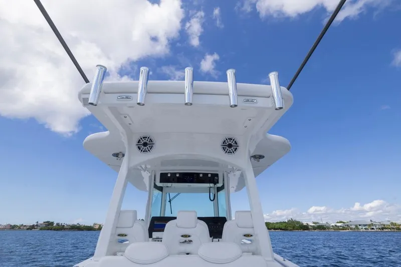 Yacht Photos Pics 2023 HCB 39 Speciale boat helm with rod holders, under a clear blue sky.