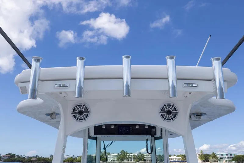  Yacht Photos Pics 2023 HCB 39 Speciale boat with rod holders and speakers against blue sky.