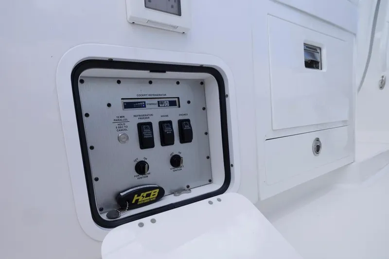  Yacht Photos Pics Control panel on 2023 HCB 39 Speciale boat, featuring switches and storage compartments.