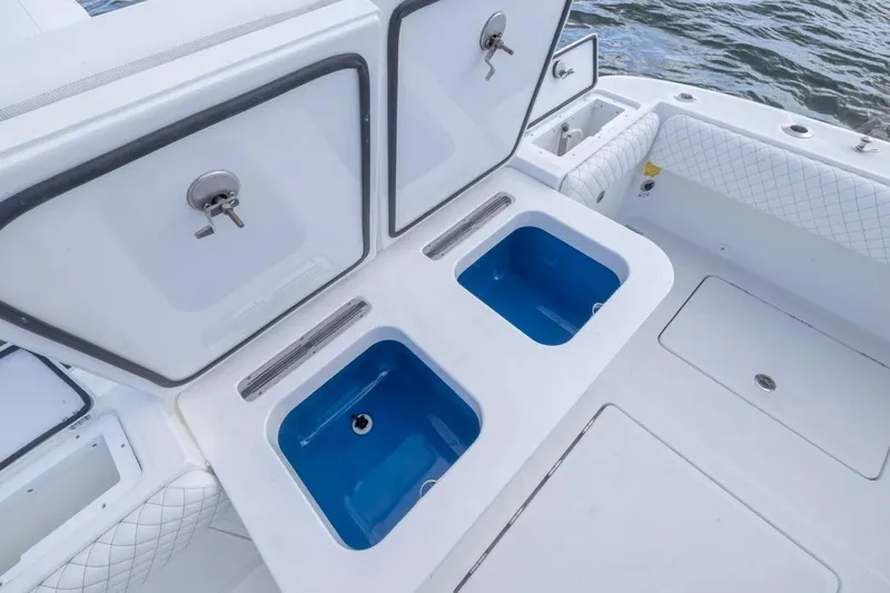  Yacht Photos Pics 2023 HCB 39 Speciale boat with open storage compartments and blue interior.