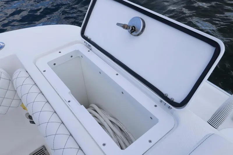  Yacht Photos Pics Open storage compartment on 2023 HCB 39 Speciale boat, featuring white interior and quilted seating.