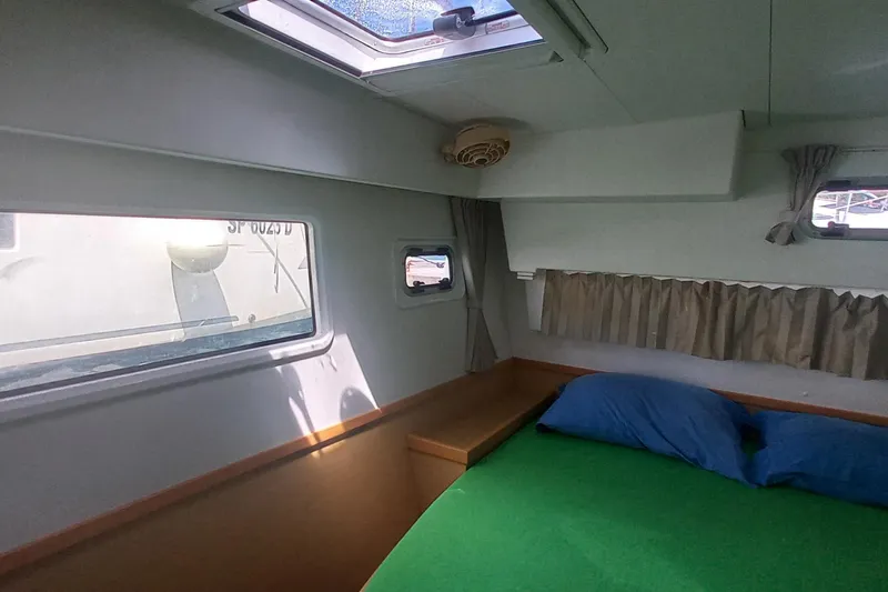 Benetnash II Yacht Photos Pics Interior cabin of 2016 Lagoon 42 catamaran with windows and bed.