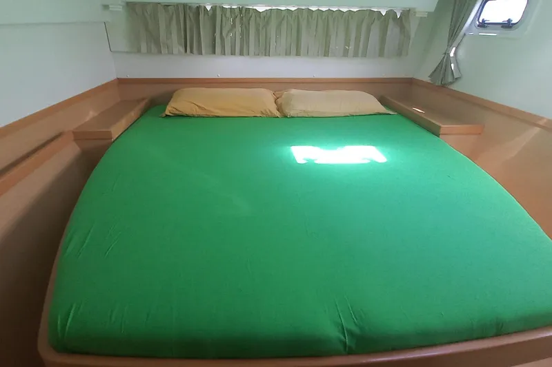 Benetnash II Yacht Photos Pics Cozy cabin bed in 2016 Lagoon 42 catamaran with green bedding and natural light.