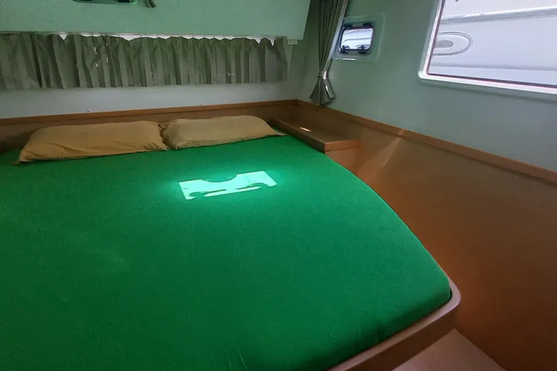 Benetnash II Yacht Photos Pics Interior cabin of 2016 Lagoon 42 catamaran with green bedding and natural light.
