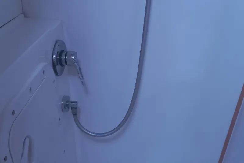 Benetnash II Yacht Photos Pics Shower area in 2016 Lagoon 42 yacht with chrome fixtures and hose.