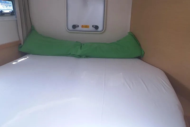 Benetnash II Yacht Photos Pics Interior cabin of 2016 Lagoon 42 catamaran with bed and green pillows.