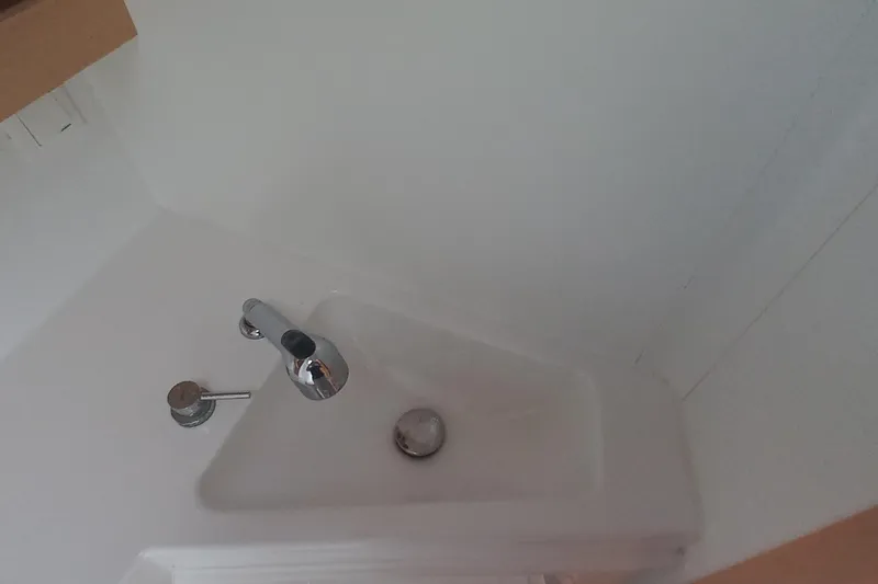 Benetnash II Yacht Photos Pics Compact white sink with chrome faucet in 2016 Lagoon 42 yacht bathroom.