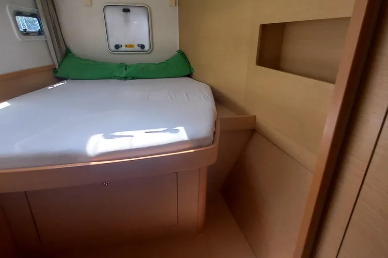 Benetnash II Yacht Photos Pics Cozy cabin interior of 2016 Lagoon 42 catamaran with bed and window.