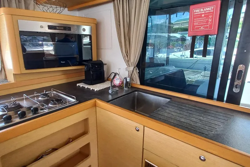 Benetnash II Yacht Photos Pics Modern kitchen interior of 2016 Lagoon 42 yacht with stove, sink, and appliances.
