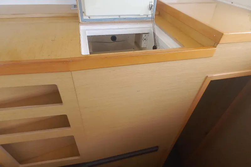 Benetnash II Yacht Photos Pics Interior view of a 2016 Lagoon 42 yacht, featuring wooden cabinetry and storage compartments.