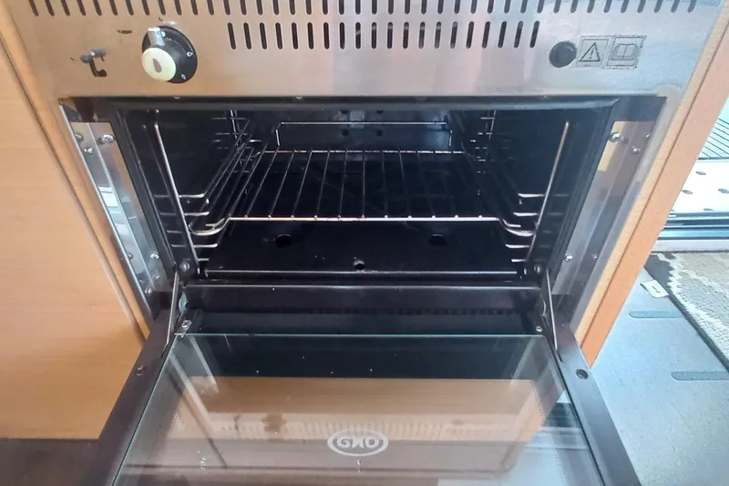 Benetnash II Yacht Photos Pics Open oven inside a 2016 Lagoon 42 catamaran kitchen, showcasing interior racks.