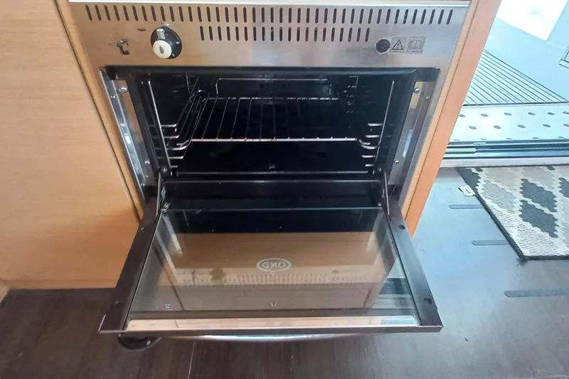 Benetnash II Yacht Photos Pics Open oven inside a 2016 Lagoon 42 catamaran kitchen, showcasing stainless steel design.