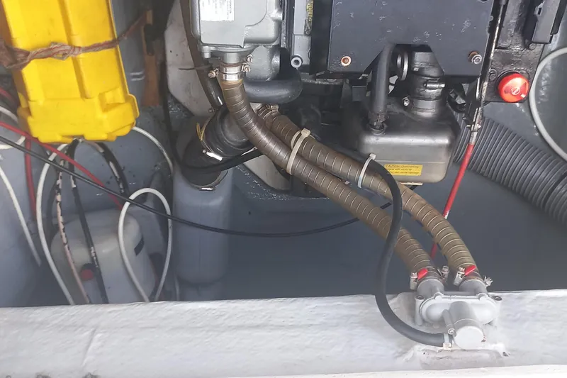 Benetnash II Yacht Photos Pics Engine compartment of a 2016 Lagoon 42 catamaran with visible hoses and wiring.
