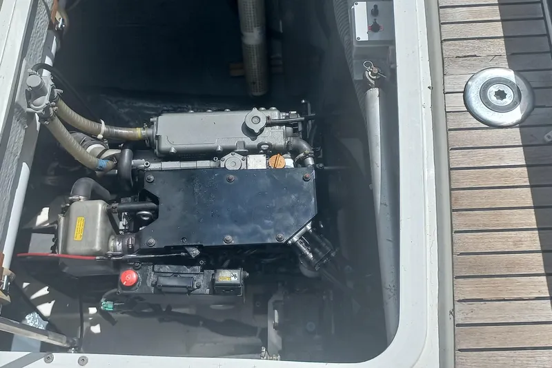 Benetnash II Yacht Photos Pics Engine compartment of a 2016 Lagoon 42 catamaran, showcasing mechanical components and deck details.