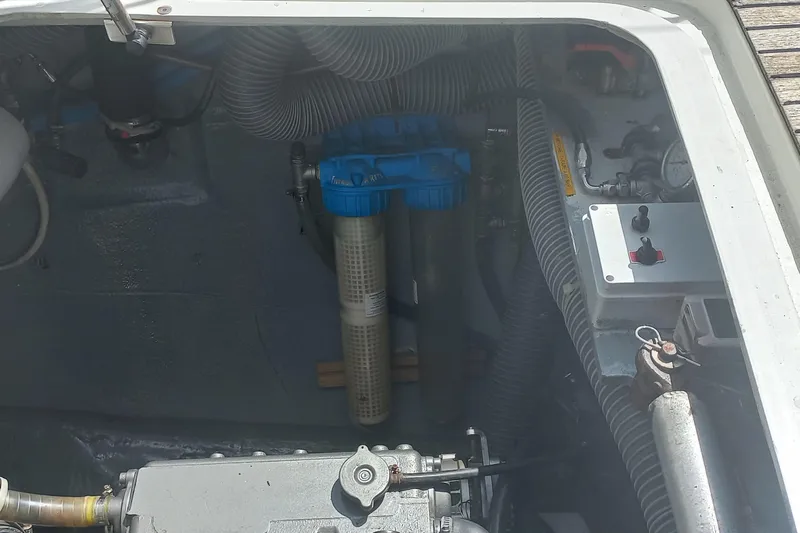 Benetnash II Yacht Photos Pics Engine compartment of a 2016 Lagoon 42 catamaran, featuring hoses and filtration system.