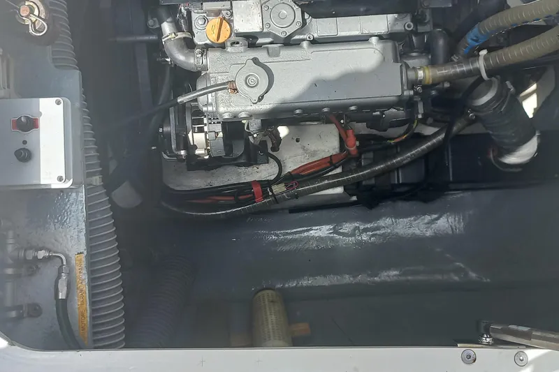 Benetnash II Yacht Photos Pics Engine compartment of a 2016 Lagoon 42 catamaran, showcasing mechanical components and wiring.