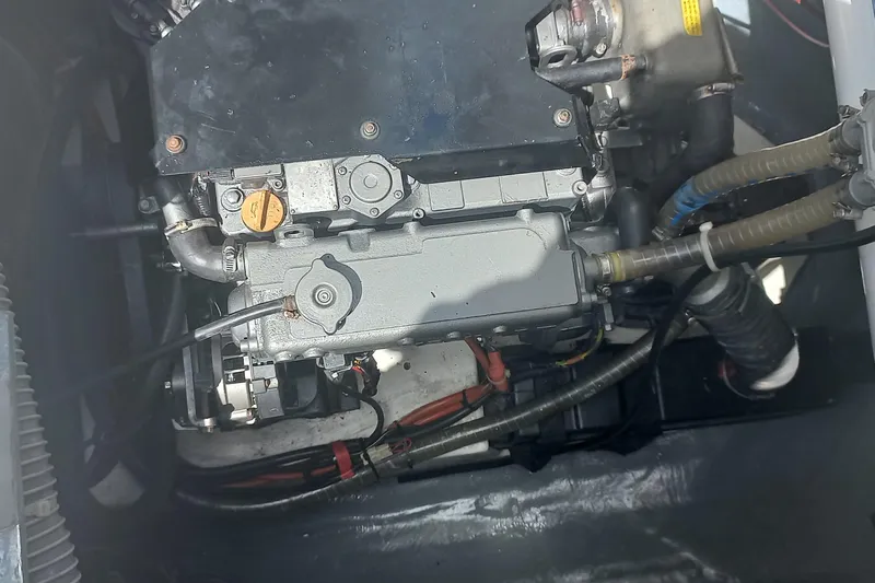Benetnash II Yacht Photos Pics Engine compartment of a 2016 Lagoon 42 catamaran, showcasing mechanical components and hoses.