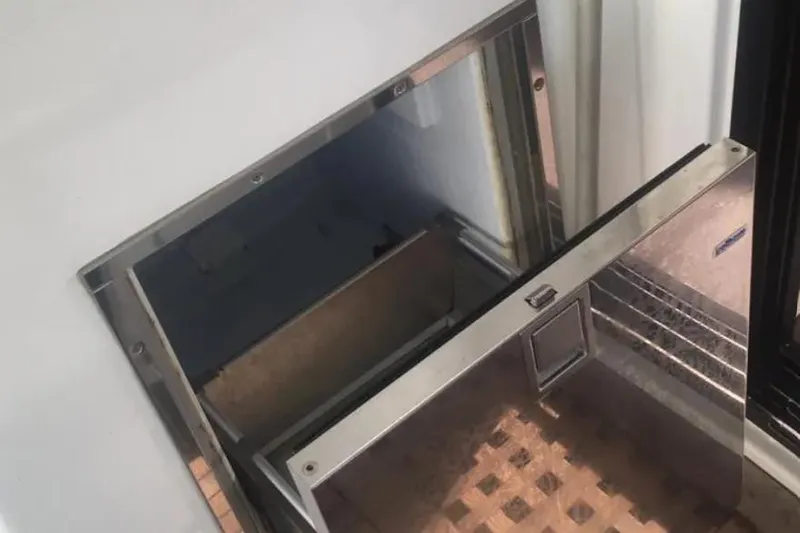 Benetnash II Yacht Photos Pics Open hatch on 2016 Lagoon 42 yacht, revealing storage compartment.